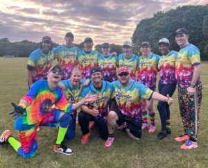 softball team in colourful jerseys under the sunset